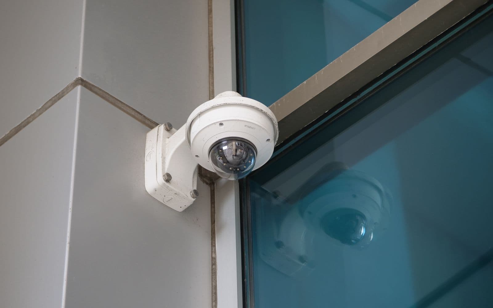 Dome CCTV camera installed on a modern commercial building